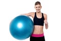 Fitness girl with aerobic ball showing thumbs sign Royalty Free Stock Photo