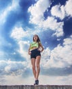 Fitness girl on the blue sky background Royalty Free Stock Photo