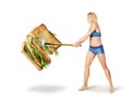 Fitness girl breaks a sandwich with a hammer on a white background