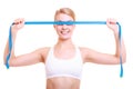 Fitness girl fit woman covering her eyes with measuring tape Royalty Free Stock Photo