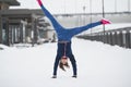 Fitness girl have acrobatic work out fitness at snow winter promenade, sport background Royalty Free Stock Photo