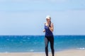 Fitness girl jogging at ocean beach on sunny day Royalty Free Stock Photo