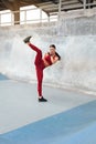 Fitness Girl Kicking. Full-Length Portrait Of Sexy Woman With Strong Muscular Body Working Out. Royalty Free Stock Photo