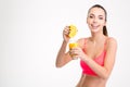 Fitness girl pressing orange juice into a glass Royalty Free Stock Photo