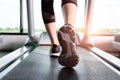 Fitness girl running on treadmill, Woman with muscular legs in g Royalty Free Stock Photo