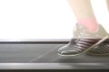 Fitness girl running on treadmill. Woman with muscular legs on w Royalty Free Stock Photo