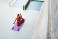 Fitness Girl. Top View Of Stretching Woman On Yoga Mat At Outdoor Stadium. Fit Female With Strong Muscular Body. Royalty Free Stock Photo