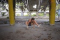 Fitness girl training hard in abandoned ruined factory building