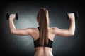 Fitness girl training shoulder muscles back view Royalty Free Stock Photo