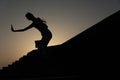 Fitness girl training on sunset, beautiful woman doing sports, silhouette of a girl is engaged in martial arts at sunset Royalty Free Stock Photo