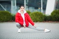 Fitness girl. Young sports woman stretching in the modern city. Healthy lifestyle in the big city Royalty Free Stock Photo