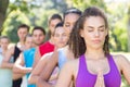 Fitness group doing yoga in park