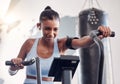 Fitness, gym and black woman on an exercise bike doing a cardio, leg and intense workout for wellness. Sports, strong