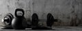 Fitness gym dumbbells and kettlebells with chrome handle and black plates in concrete room background, muscle exercise,