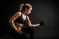 Fitness in gym, sport and healthy lifestyle concept. Beautiful athletic woman showing her trained body on black Royalty Free Stock Photo