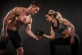 Fitness in gym, sport and healthy lifestyle concept. Couple of athletic man and woman showing their trained bodies on