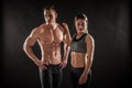 Fitness in gym, sport and healthy lifestyle concept. Couple of athletic man and woman showing their trained bodies on