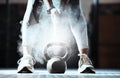 Fitness, hands and powder at kettlebell in gym for workout, exercise and sports training. Closeup, athlete and legs of