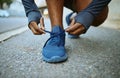 Fitness, hands and shoes on man in a road for lace tie, exercise and running in a city, closeup and cardio. Hand, feet
