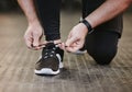 Fitness, hands and tie shoes in gym to start workout, training or exercise for wellness. Sports, athlete and man tying Royalty Free Stock Photo
