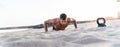 Fitness handsome man exercising on the beach during sunset, outdoor. Personal trainer working out