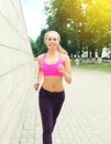 Fitness happy smiling woman running in city park, female runner workout, sport and healthy lifestyle Royalty Free Stock Photo