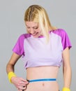 Fitness and health. Female slim waist belly and tape measure. Athlete fitness coach training. Trying to slim down. Get Royalty Free Stock Photo