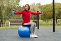 Fitness ,Healthy, Aerobics, Workout, Smiling Young Woman doing exercise with pilates ball on the workout playground Royalty Free Stock Photo