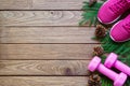 Fitness and Healthy Christmas sport composition. Flat lay of sport shoes, dumbbells pine leaves and pine cones. Merry christmas Royalty Free Stock Photo