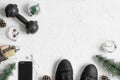 Fitness and Healthy Christmas sport composition. Overhead shot of sport shoes, dumbbells, skipping rope and Christmas ornaments Royalty Free Stock Photo