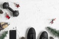 Fitness and Healthy Christmas sport composition. Overhead shot of sport shoes, dumbbells, skipping rope and Christmas ornaments Royalty Free Stock Photo