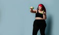 Fitness healthy diet weight loss concept. Lucky plus-size girl overweight woman dieting working out with green weights dumbbells Royalty Free Stock Photo