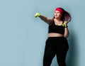 Fitness healthy diet weight loss concept. Lucky plus-size girl overweight woman dieting working out with green weights dumbbells Royalty Free Stock Photo