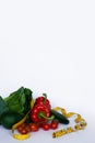 Fitness and healthy food diet concept. Fresh green vegetables, measuring tape on white background.