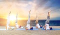 People doing yoga shoulderstand on mat outdoors Royalty Free Stock Photo