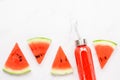 Fitness, healthy nutrition diet concept. Fresh cool watermelon juice in a glass jar and watermelon slices on a light background. Royalty Free Stock Photo