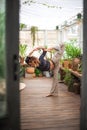 Fitness home exercise concept. A woman practices yoga and Pilates at home. Eco friendly house. Urban Jungle and Yoga.