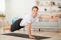 Fitness at home. Smiling athletic trainer doing exercises for sports blog
