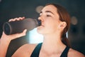 Fitness, hydration and female athlete drinking water for thirst, wellness and health in a training studio. Sports Royalty Free Stock Photo