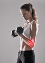 Fitness, injury and elbow pain, woman and red glow for muscle tension with dumbbell on white background. Exercise