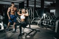 Fitness instructor exercising with his client at the gym. Royalty Free Stock Photo