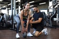 Fitness instructor exercising with his client at the gym Royalty Free Stock Photo