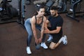 Fitness instructor exercising with his client at the gym Royalty Free Stock Photo