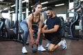 Fitness instructor exercising with his client at the gym Royalty Free Stock Photo