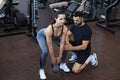 Fitness instructor exercising with his client at the gym Royalty Free Stock Photo