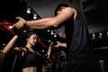 Fitness instructor with girl on training in fitness center