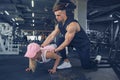 Fitness instructor help girl to do push ups on training in fitness center Royalty Free Stock Photo