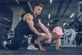 Fitness instructor help girl to do push ups on training in fitne Royalty Free Stock Photo