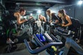 Fitness instructor leading female cycling class in gym Royalty Free Stock Photo