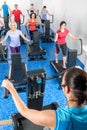 Fitness instructor leading treadmill running class